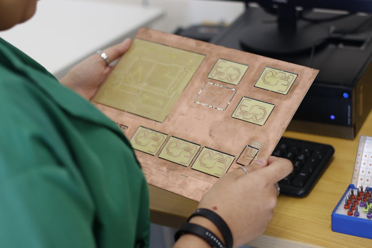 a technician holding an electric board with copper blocks