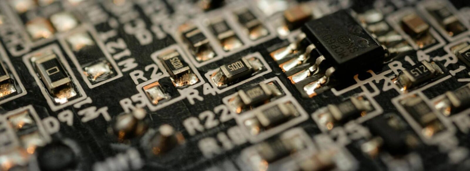 A close-up photo of a printed circuit board with plated components.