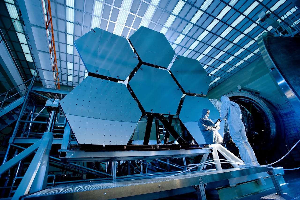 Engineers standing in front of massive hexagonal panels