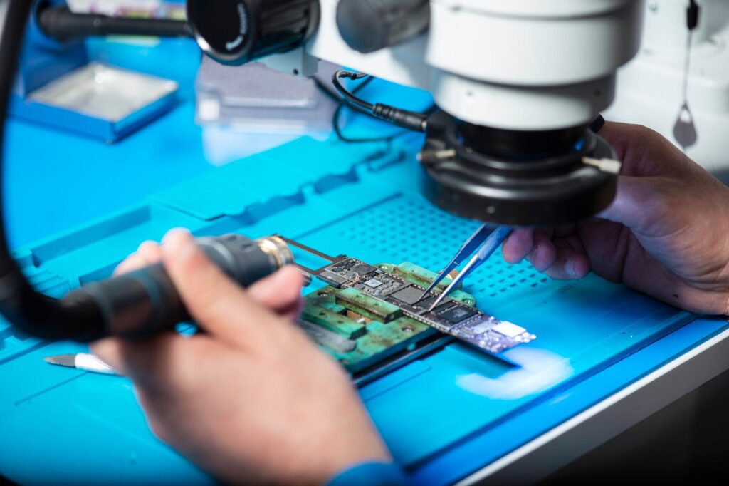 A person’s hands working on computer hardware